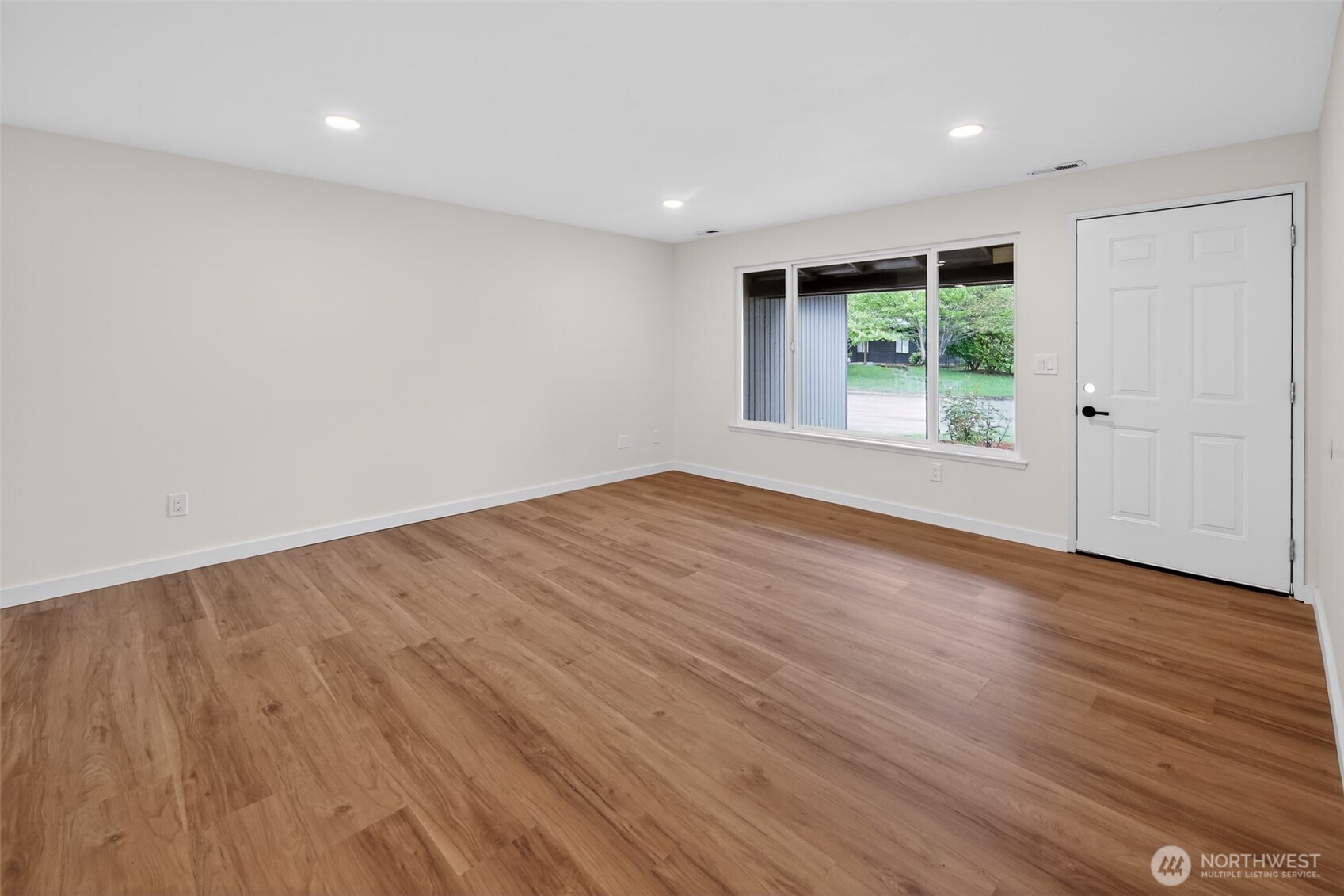 320 213th Place Southwest Bothell, WA 98021 - Photo 25 of 29 a view of an empty room with wooden floor and a window
