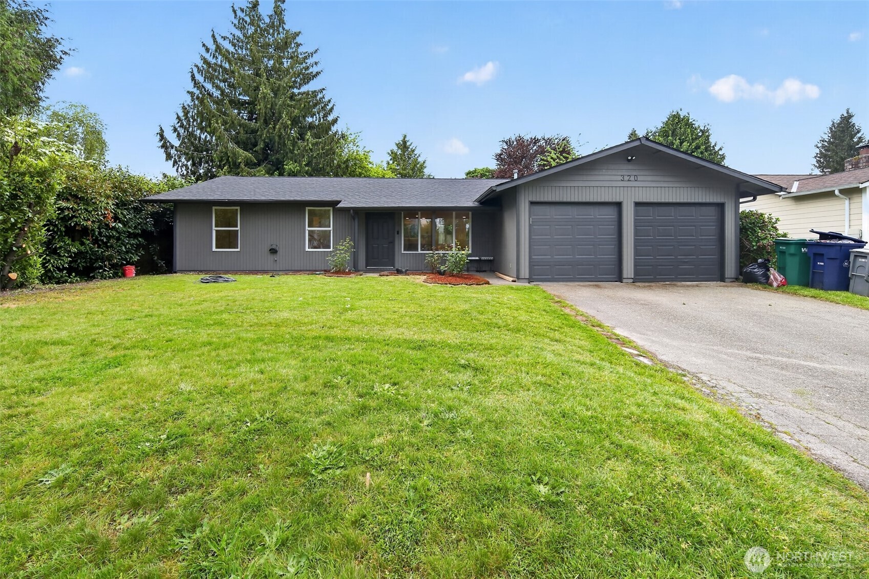 320 213th Place Southwest Bothell, WA 98021 - Photo 28 of 29 a front view of a house with a garden and yard