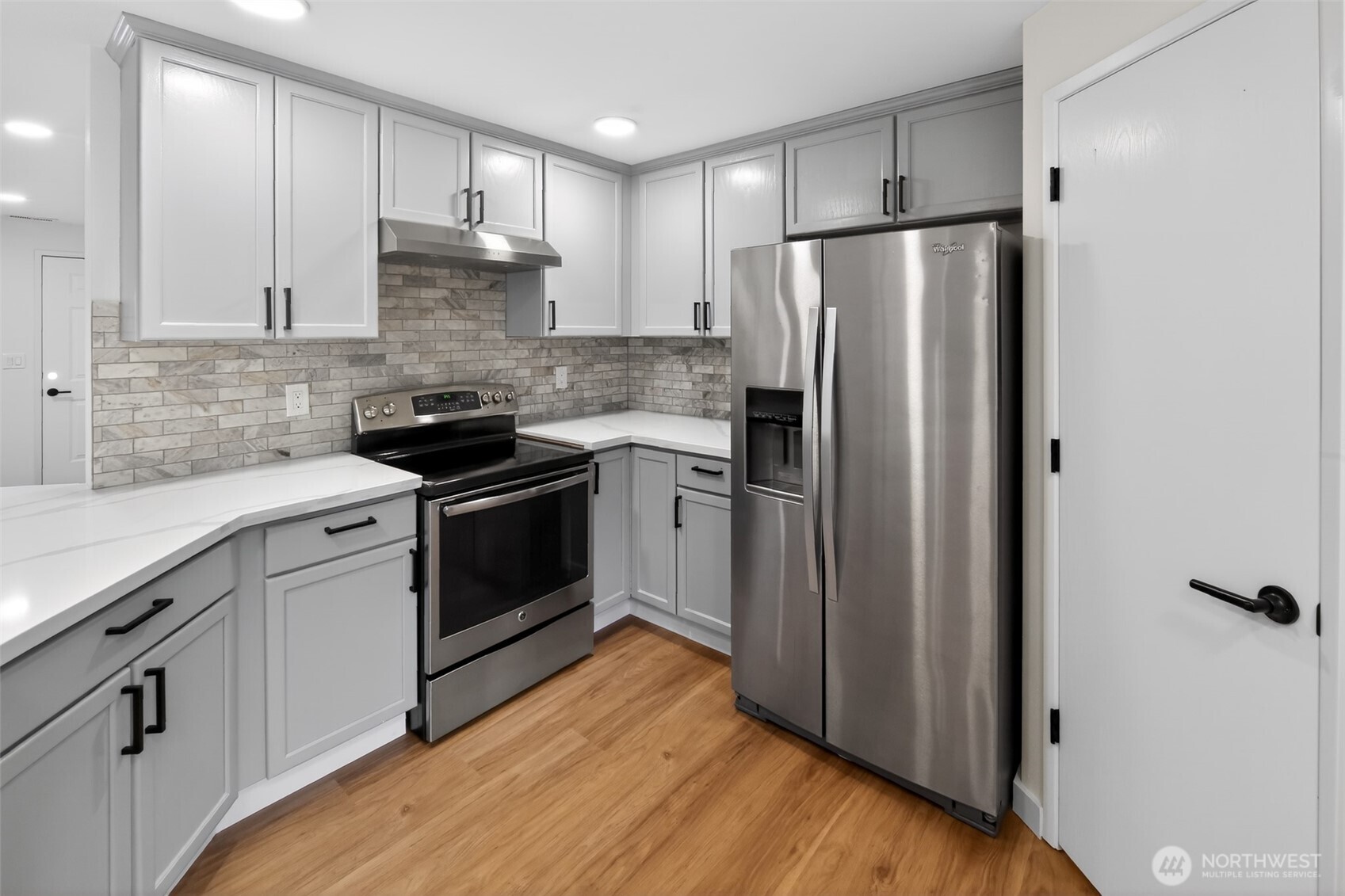 320 213th Place Southwest Bothell, WA 98021 - Photo 7 of 29 a kitchen with a refrigerator sink and cabinets
