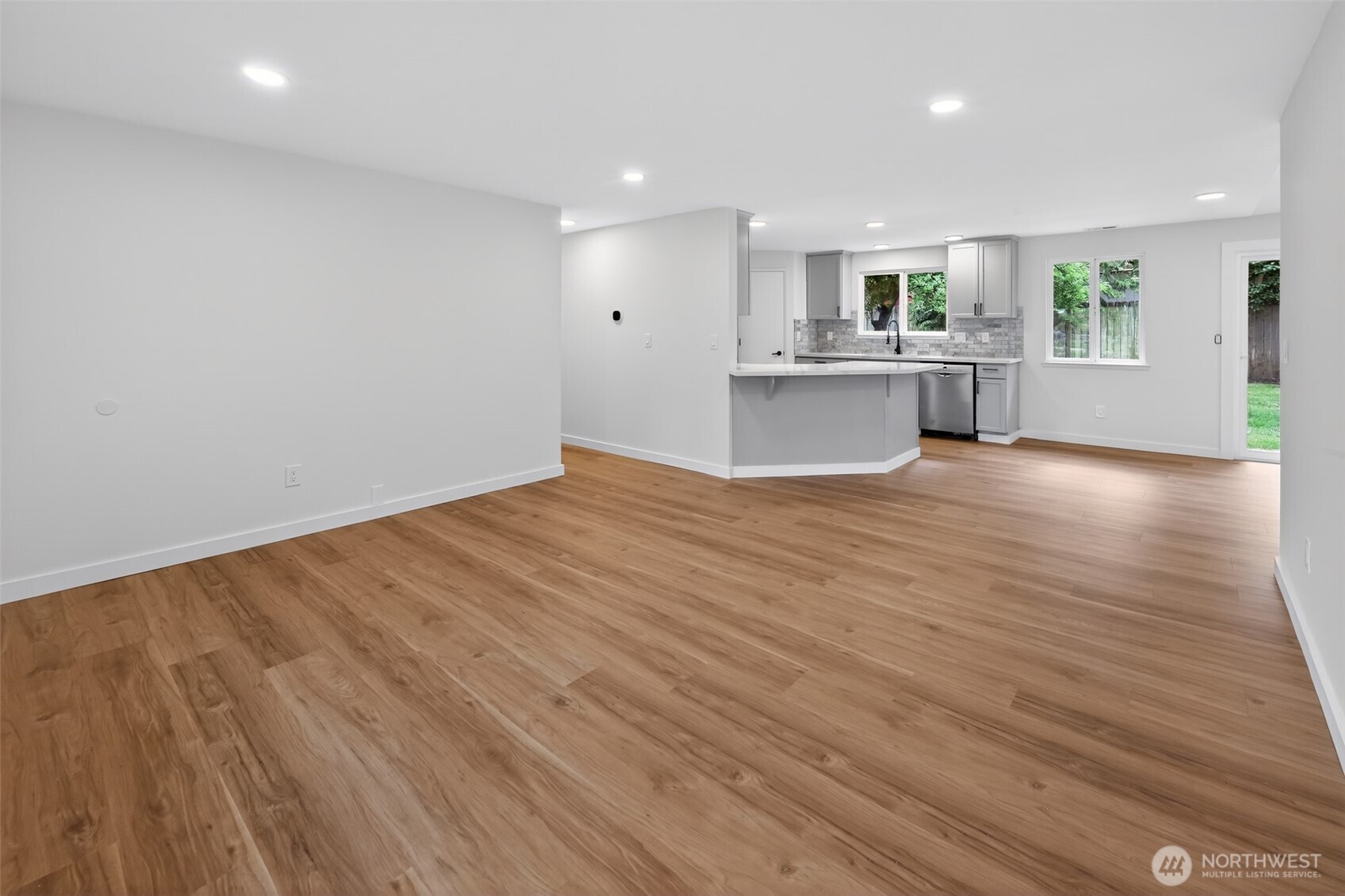 320 213th Place Southwest Bothell, WA 98021 - Photo 10 of 29 a view of a kitchen with wooden floor and windows