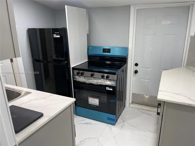 a kitchen with a sink appliances and cabinets