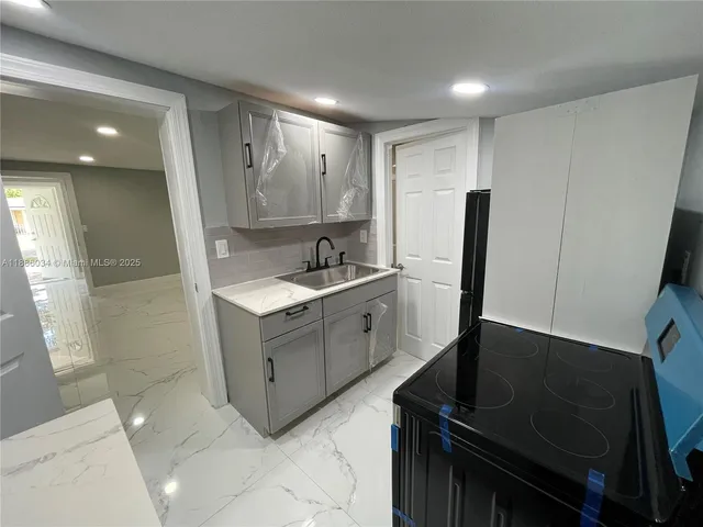 a kitchen with a stove and a refrigerator