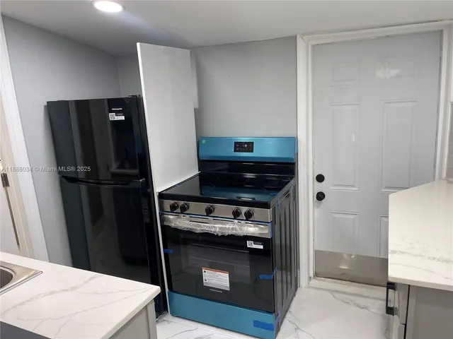 a kitchen with a stove and a refrigerator