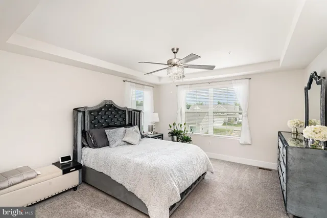 a bedroom with a large bed and a chandelier