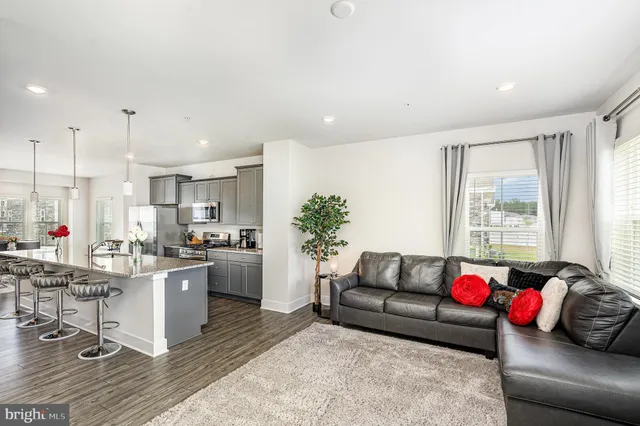 a living room with furniture and kitchen view