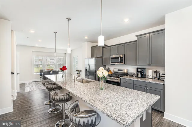 a kitchen with sink refrigerator and cabinets