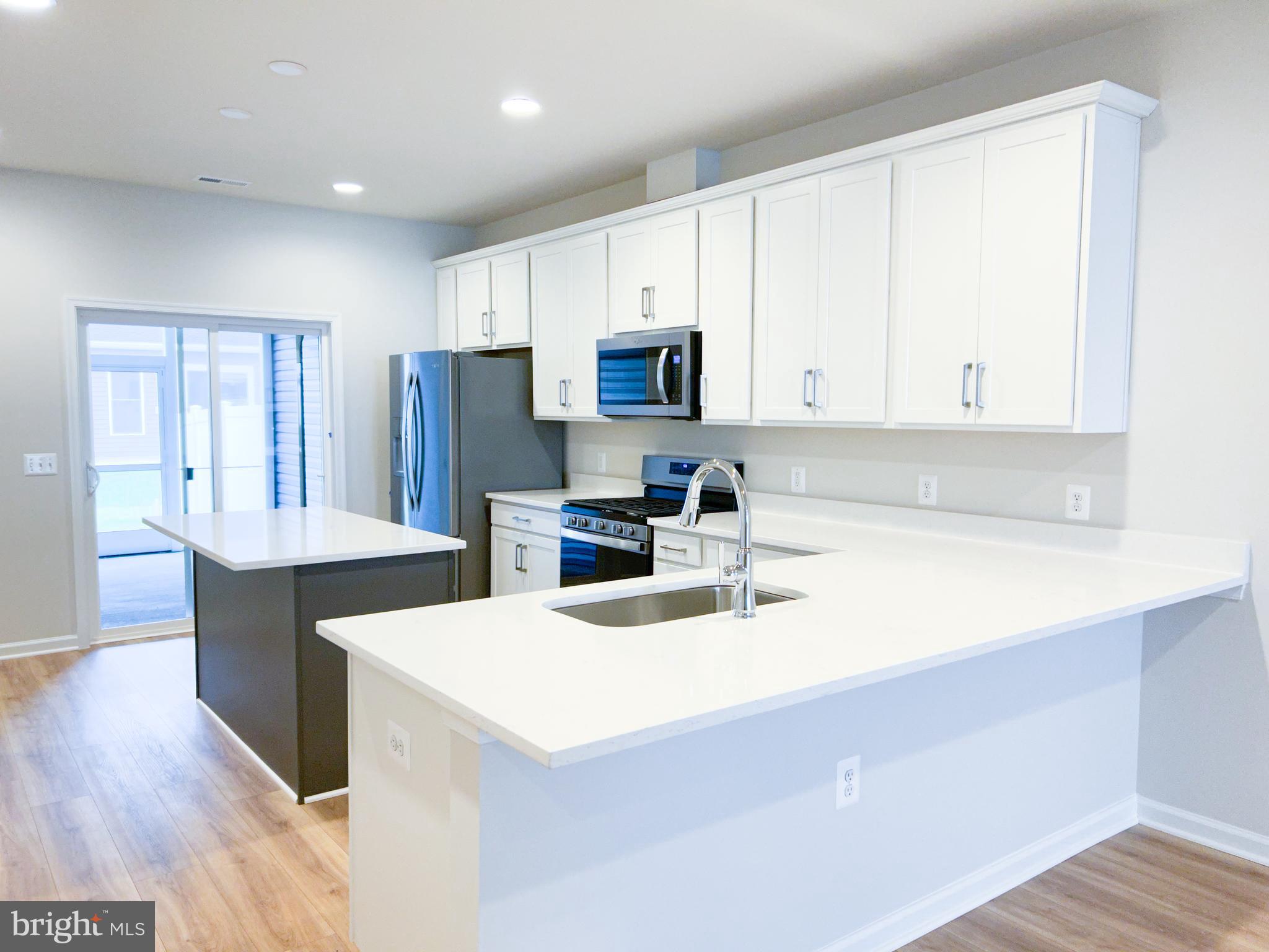 119 Heirloom Way Winchester, VA 22603 - Photo 5 of 26 a kitchen with refrigerator and cabinets