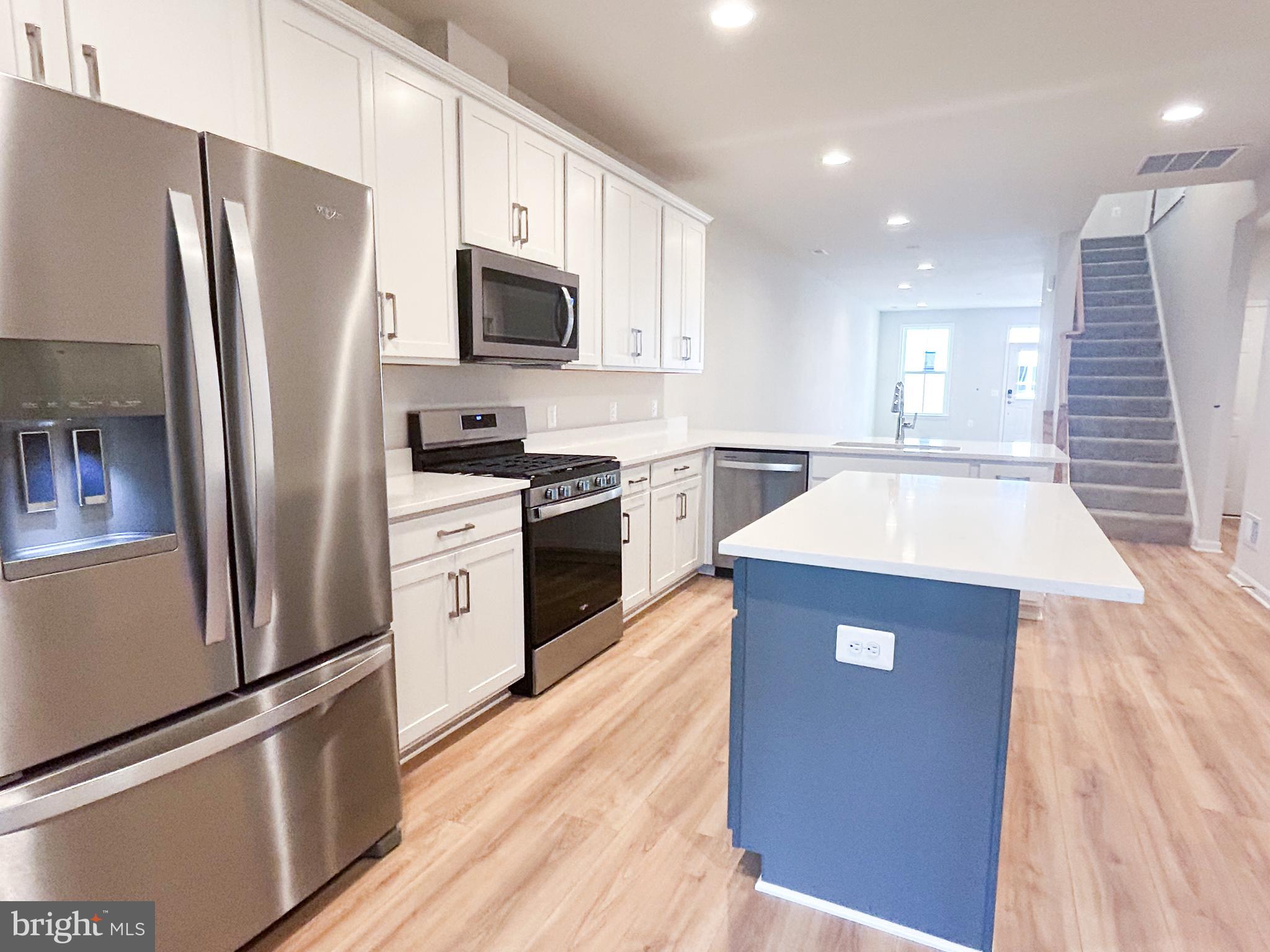 119 Heirloom Way Winchester, VA 22603 - Photo 10 of 26 a kitchen with stainless steel appliances granite countertop a refrigerator a stove top oven a sink and dishwasher