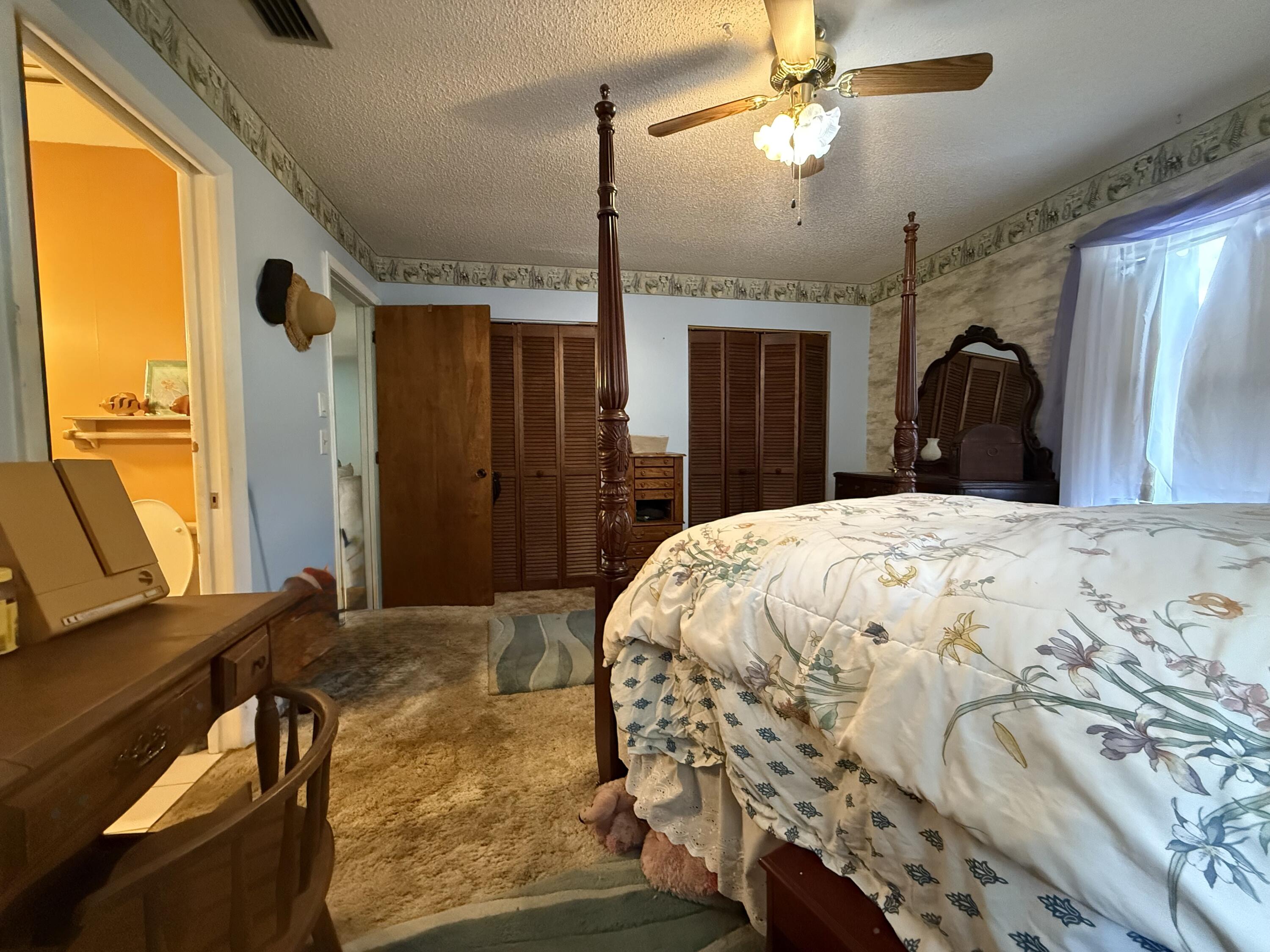 945 33rd Avenue Southwest Vero Beach, FL 32968 - Photo 11 of 22 a bed sitting in a bedroom next to a window