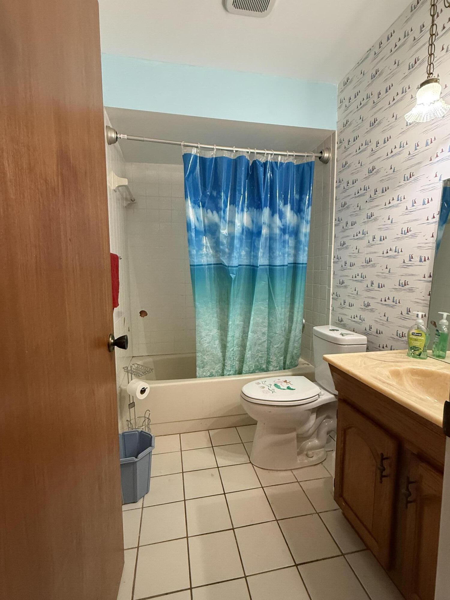 945 33rd Avenue Southwest Vero Beach, FL 32968 - Photo 17 of 22 a bathroom with a sink a toilet and tub