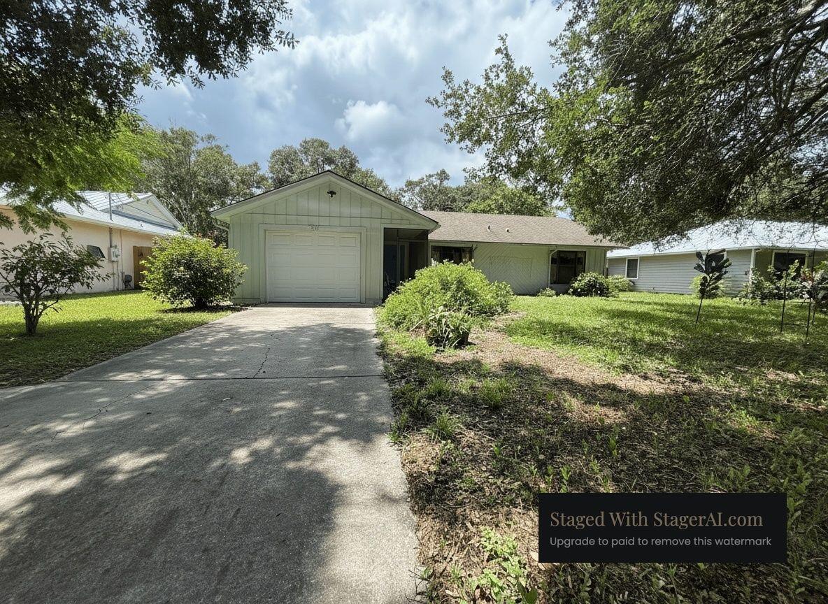 945 33rd Avenue Southwest Vero Beach, FL 32968 - Photo 2 of 22 a front view of a house with garden