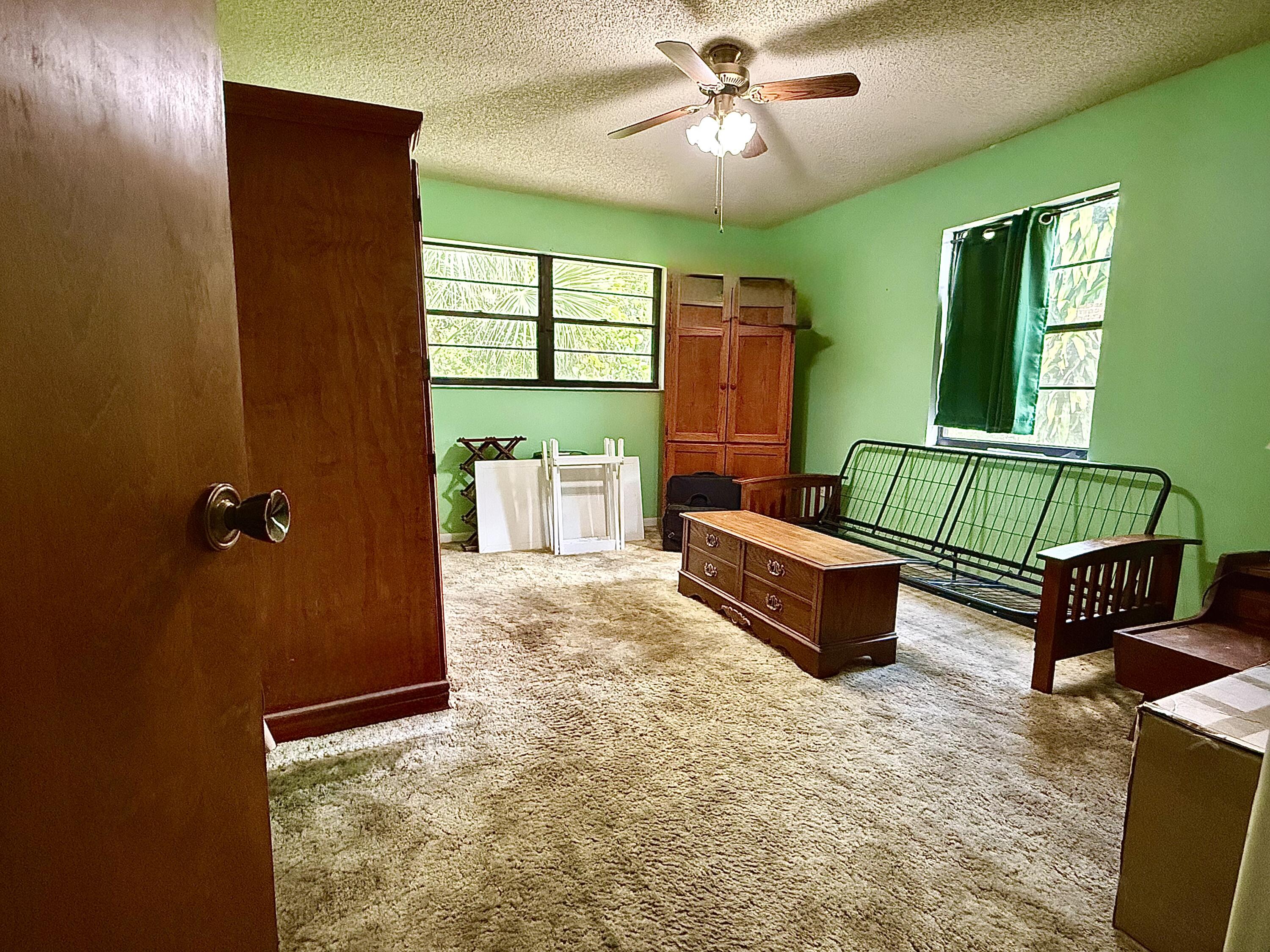 945 33rd Avenue Southwest Vero Beach, FL 32968 - Photo 6 of 22 a bedroom with a bed and window