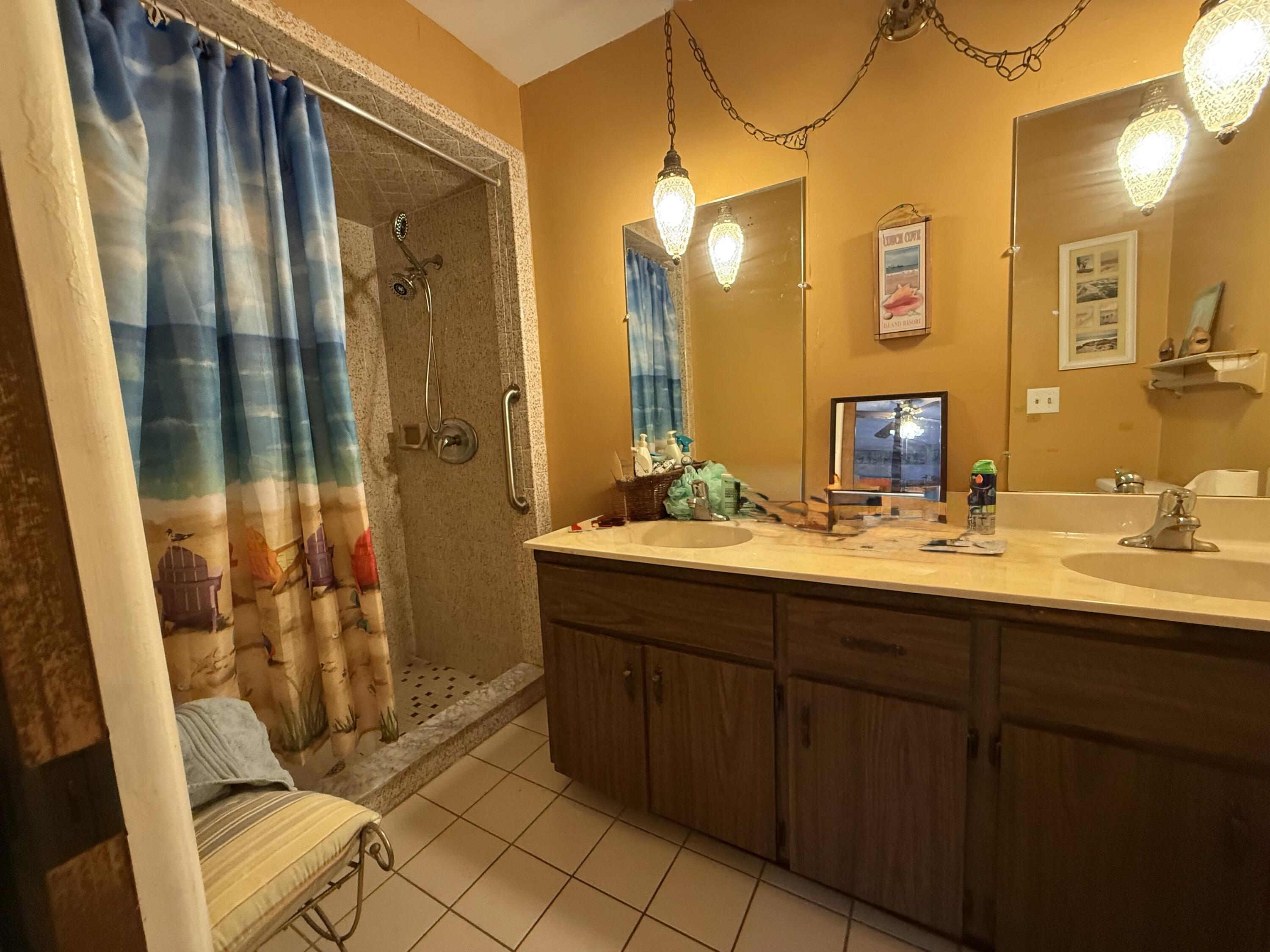 945 33rd Avenue Southwest Vero Beach, FL 32968 - Photo 8 of 22 a bathroom with a double vanity sink and mirror