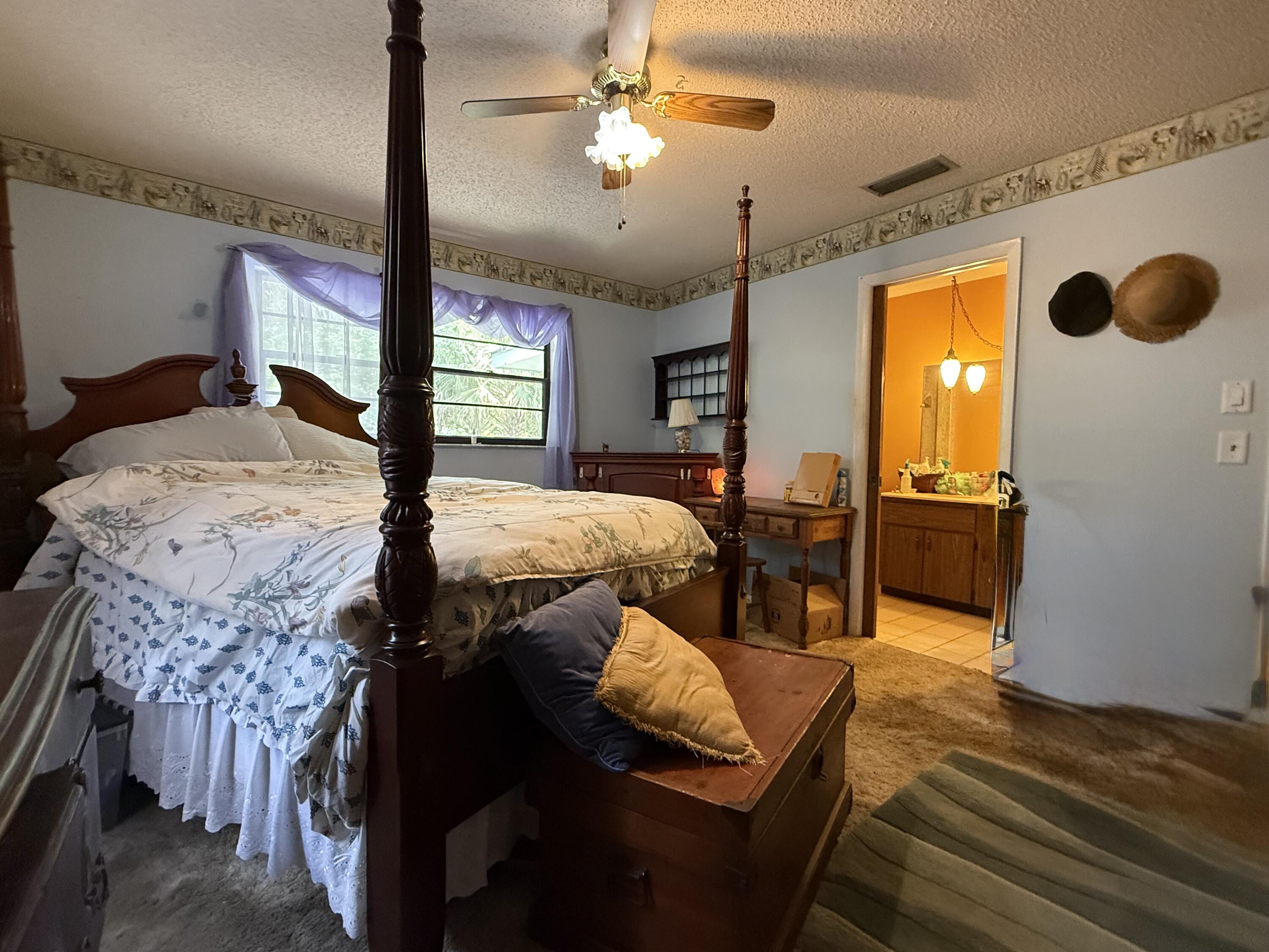 945 33rd Avenue Southwest Vero Beach, FL 32968 - Photo 10 of 22 a bedroom with a bed and wooden floor