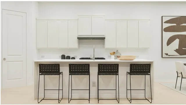 a kitchen with a sink appliances and cabinets