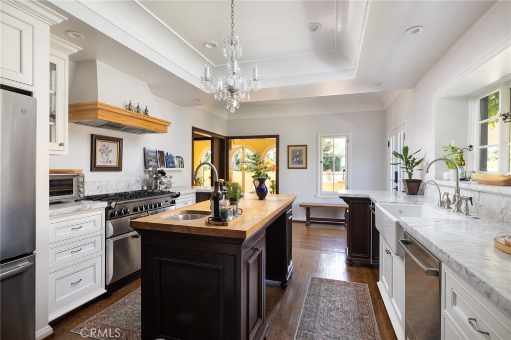 100 Temple Avenue Long Beach, CA 90803 - Photo 17 of 57 a kitchen with kitchen island granite countertop a sink appliances cabinets and furniture