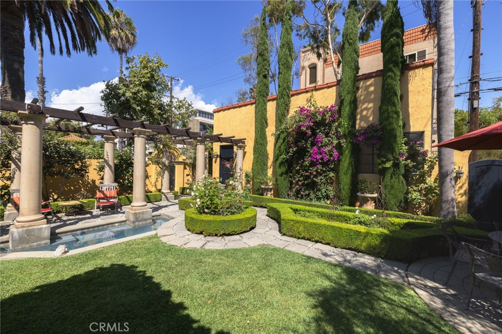 100 Temple Avenue Long Beach, CA 90803 - Photo 39 of 57 a front view of a house with a yard table and chairs