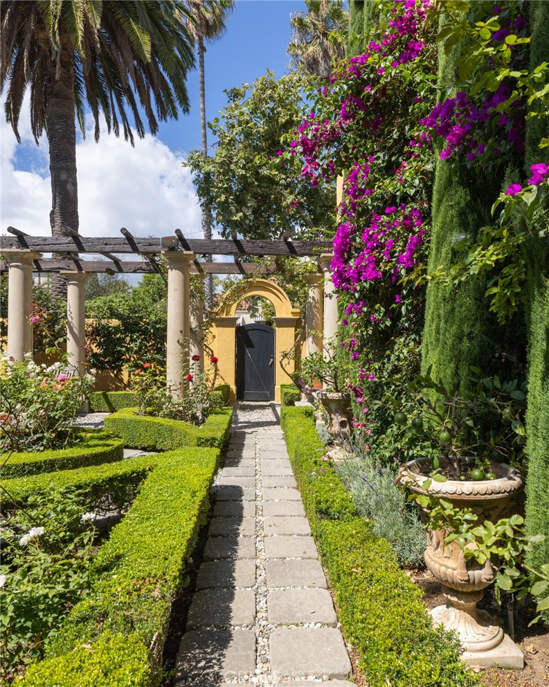 100 Temple Avenue Long Beach, CA 90803 - Photo 43 of 57 a front view of a house with a fountain and potted plant