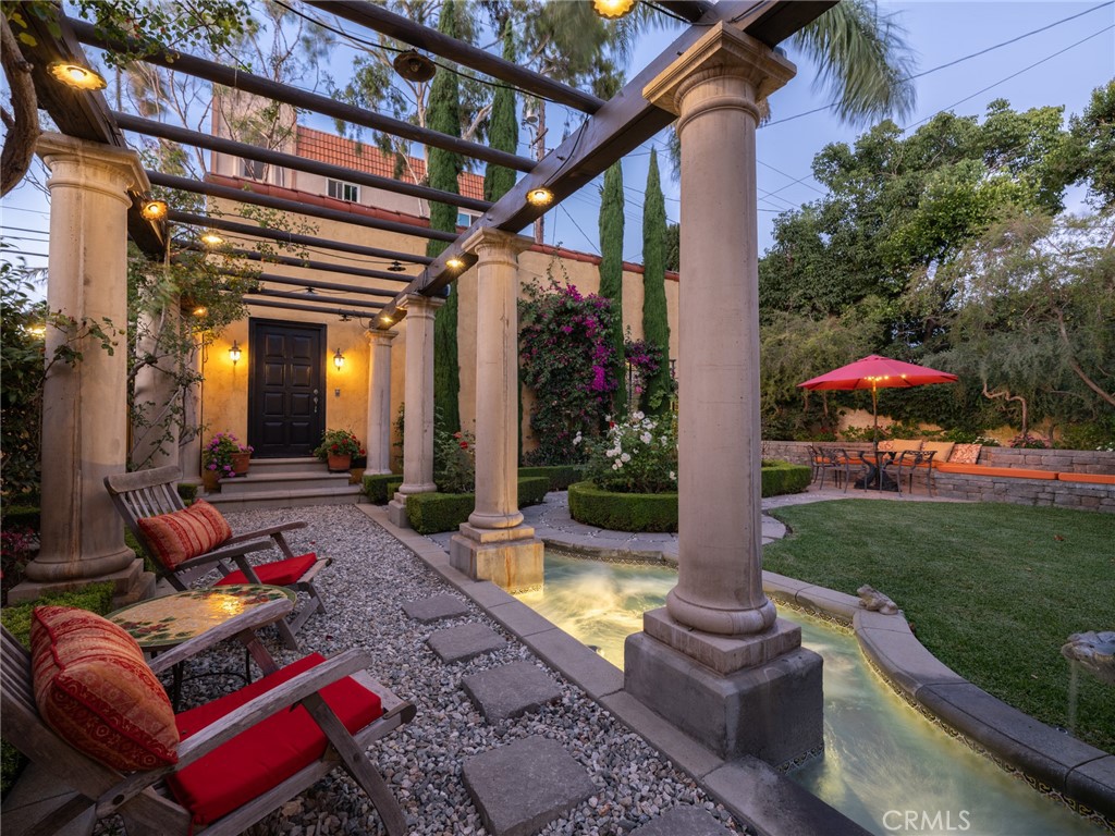 100 Temple Avenue Long Beach, CA 90803 - Photo 54 of 57 a view of a patio with table and chairs potted plants and a palm tree