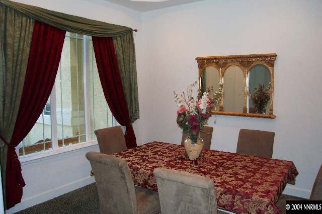 5614 North White Sands Road Reno, NV 89511 - Photo 3 of 9 a living room with furniture and a window