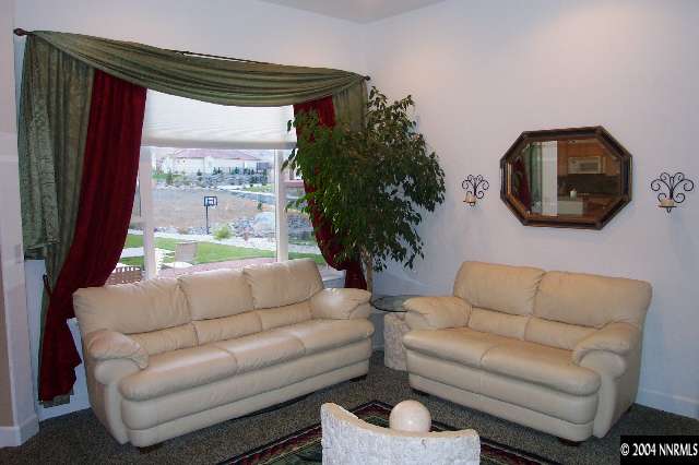 5614 North White Sands Road Reno, NV 89511 - Photo 4 of 9 a living room with furniture and a large window