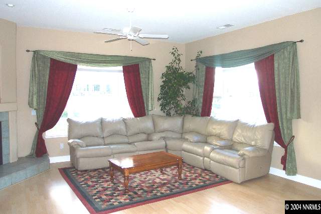 5614 North White Sands Road Reno, NV 89511 - Photo 6 of 9 a living room with furniture and a large window