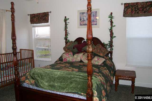 5614 North White Sands Road Reno, NV 89511 - Photo 7 of 9 a bedroom with a bed and a window