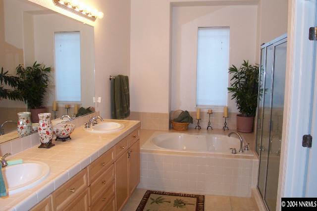5614 North White Sands Road Reno, NV 89511 - Photo 8 of 9 a bathroom with a sink and a mirror