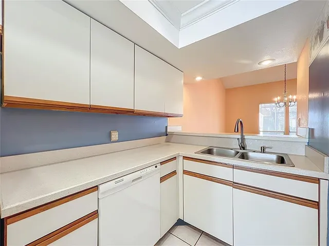 a kitchen with a sink cabinets and a window