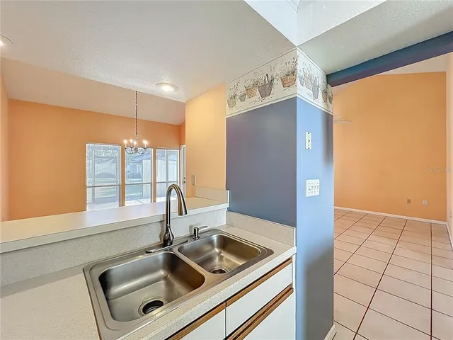 a kitchen with a sink and a refrigerator