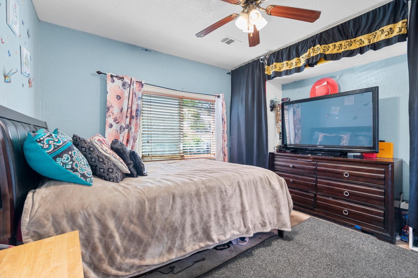 2009 69th Avenue Oakland, CA 94621 - Photo 11 of 16 a bedroom with a bed and a flat screen tv