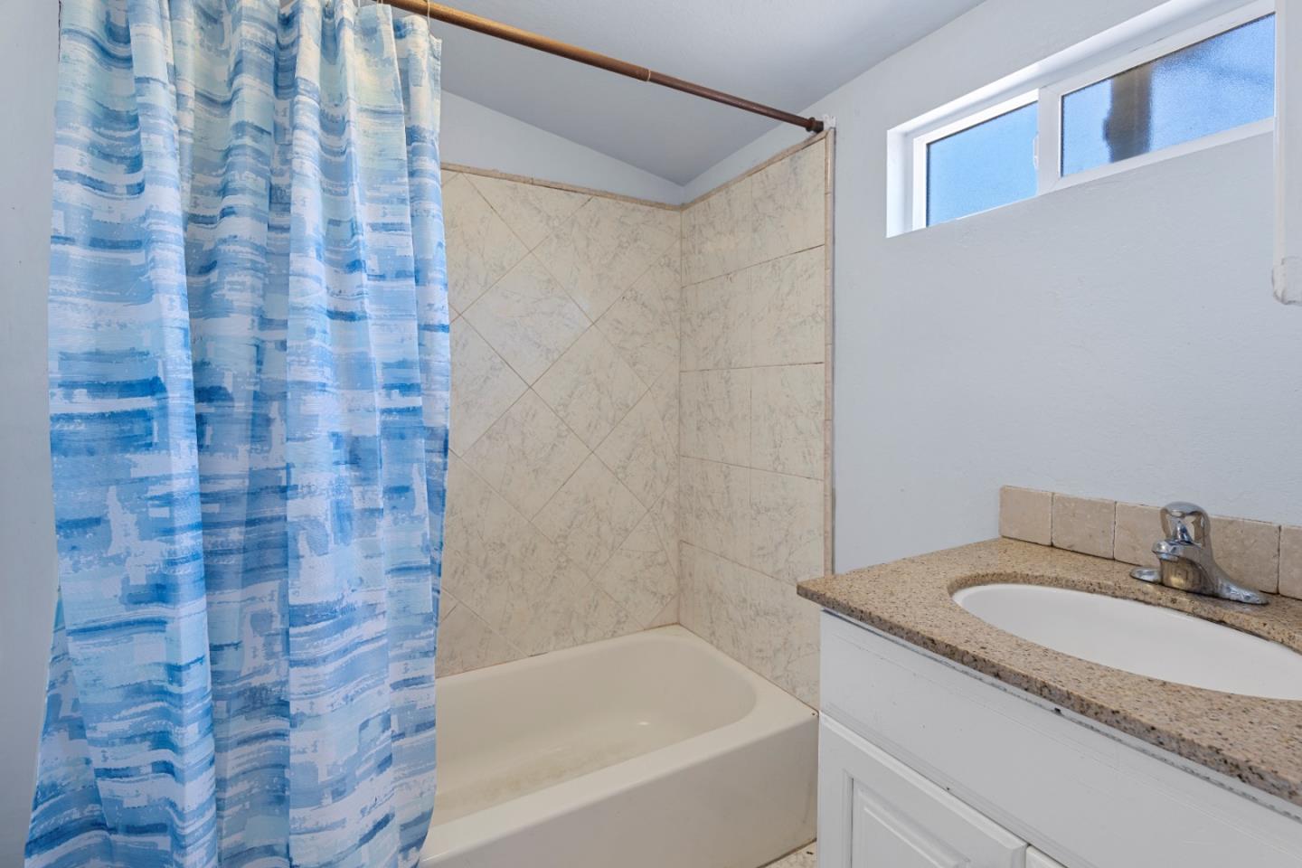2009 69th Avenue Oakland, CA 94621 - Photo 13 of 16 a bathroom with a granite countertop sink toilet and bathtub