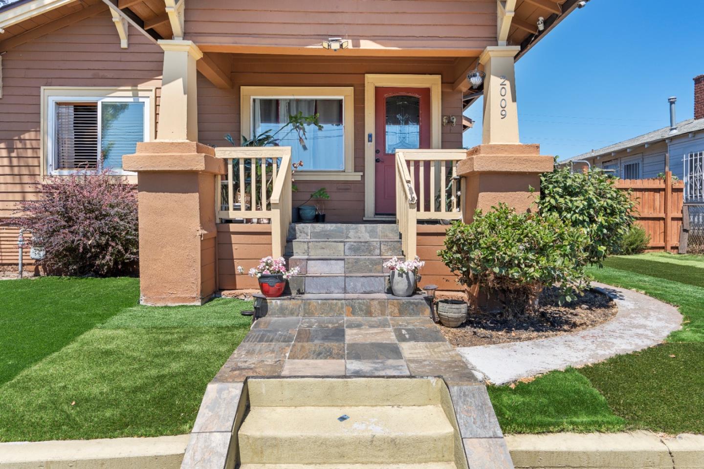 2009 69th Avenue Oakland, CA 94621 - Photo 2 of 16 a front view of a house with garden