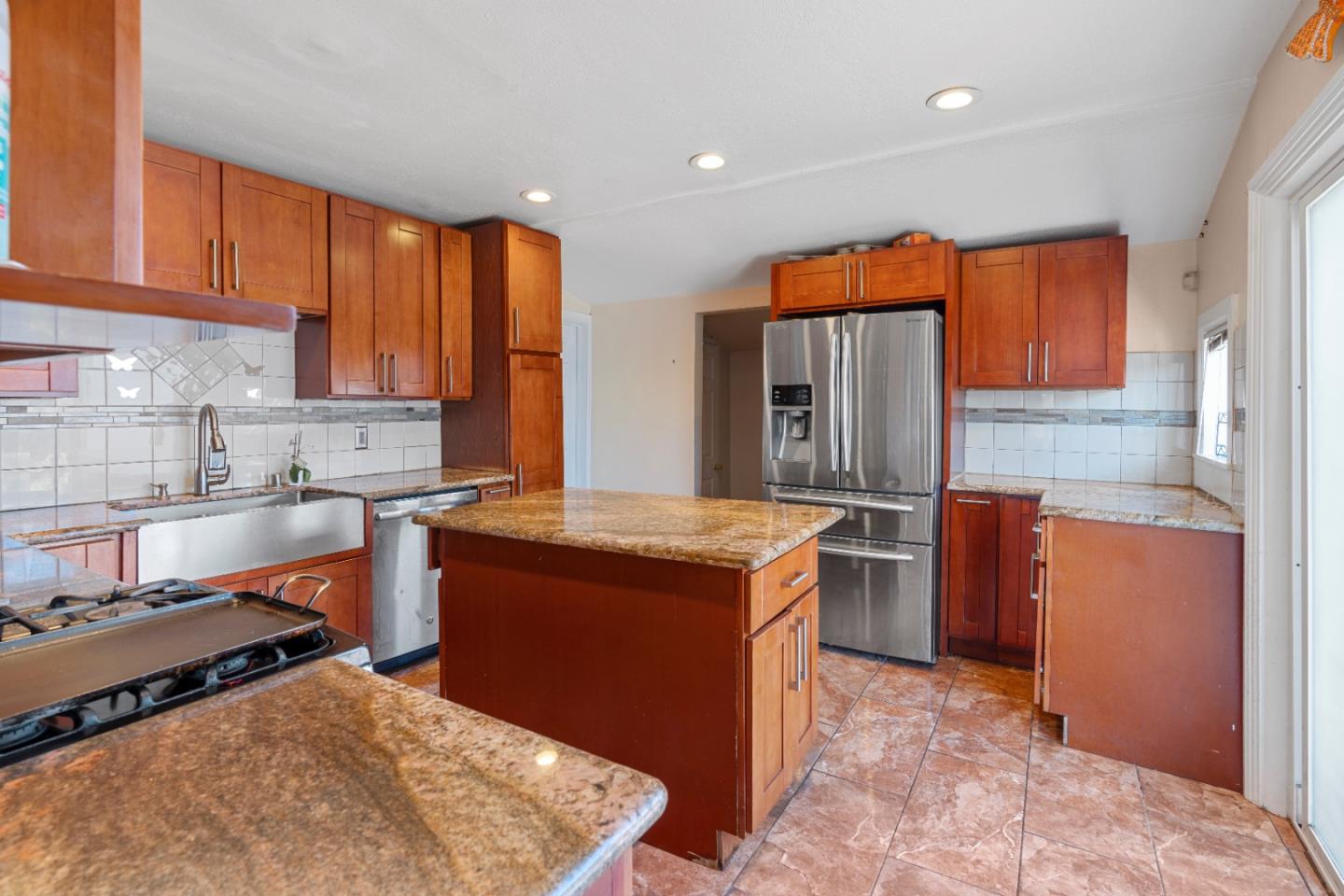 2009 69th Avenue Oakland, CA 94621 - Photo 7 of 16 a kitchen with stainless steel appliances granite countertop a stove a sink and a microwave
