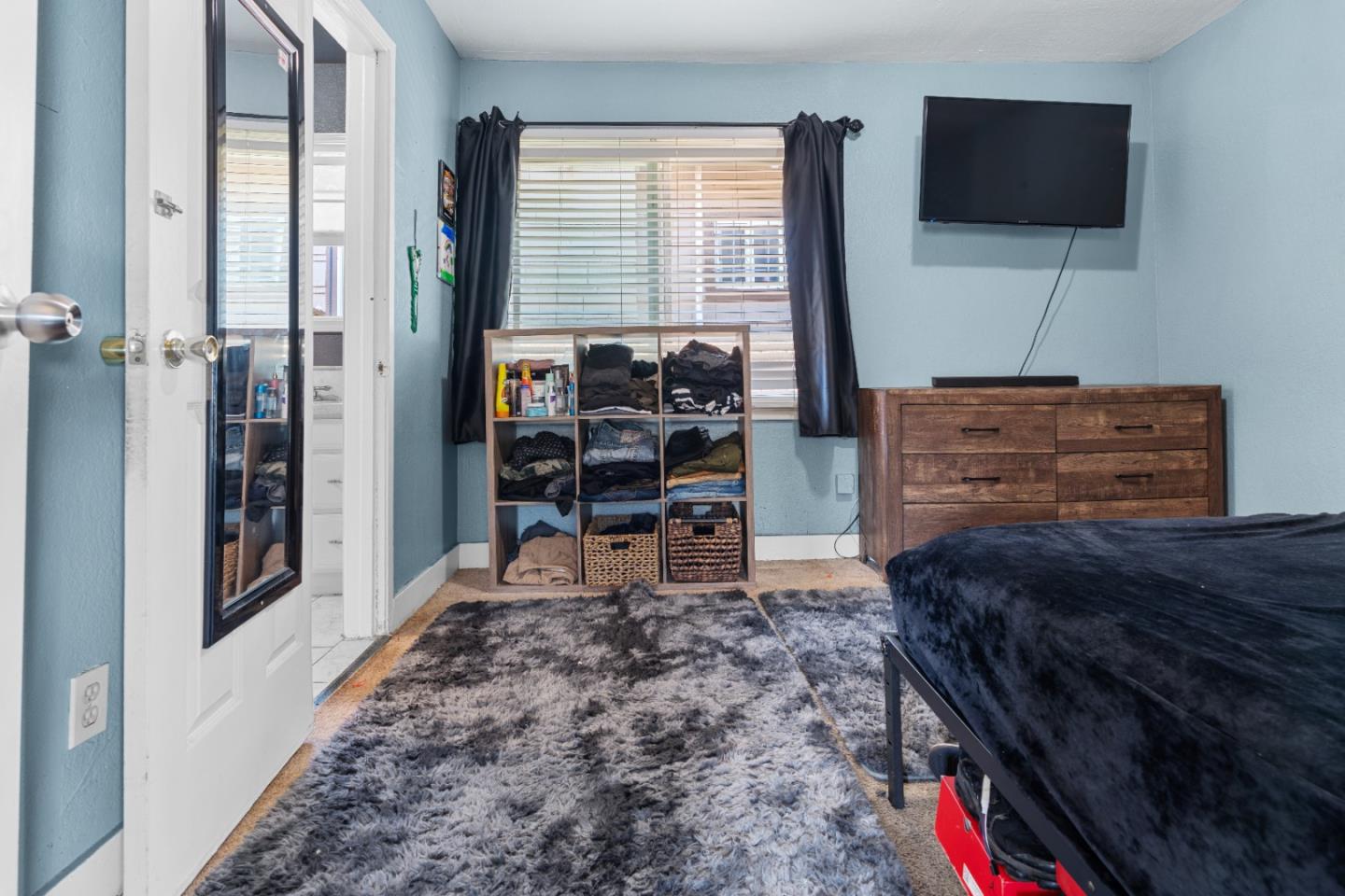 2009 69th Avenue Oakland, CA 94621 - Photo 9 of 16 a bed room with a bed and a television