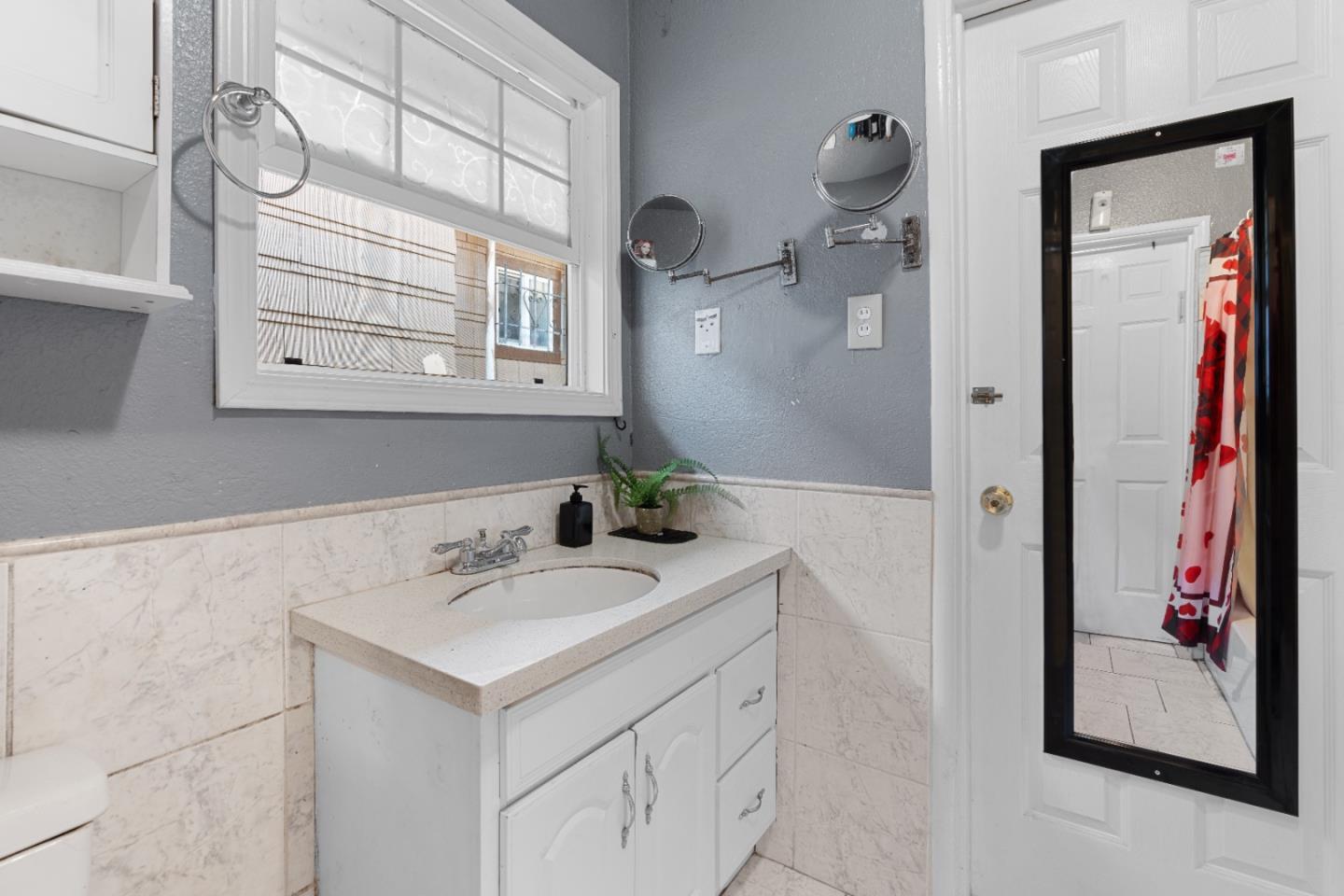 2009 69th Avenue Oakland, CA 94621 - Photo 10 of 16 a bathroom with a sink and a mirror
