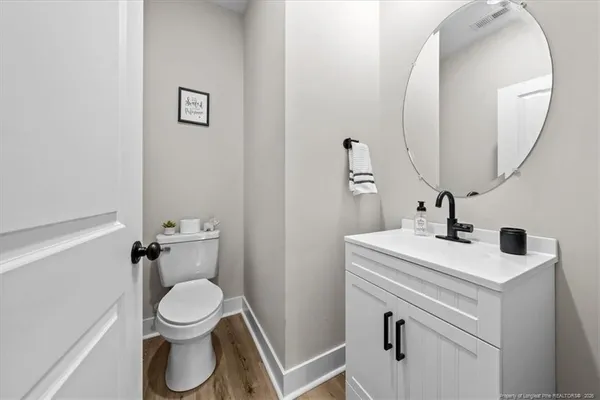a bathroom with a toilet a sink and a mirror