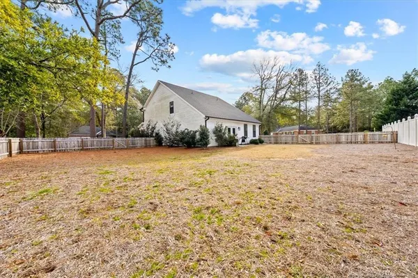 a view of yard with tree in front of it