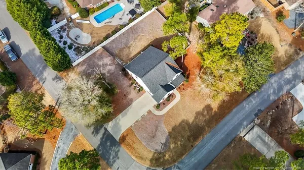 an aerial view of a house with a swimming pool