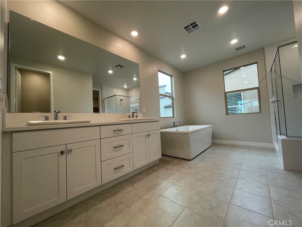 145 Denali Lake Forest, CA 92630 - Photo 12 of 17 a spacious bathroom with a double vanity sink mirror and bathtub