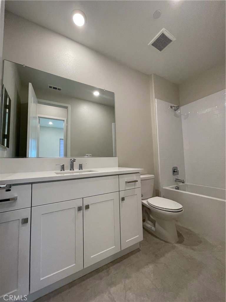 145 Denali Lake Forest, CA 92630 - Photo 14 of 17 a bathroom with a toilet a sink a mirror and a bathtub
