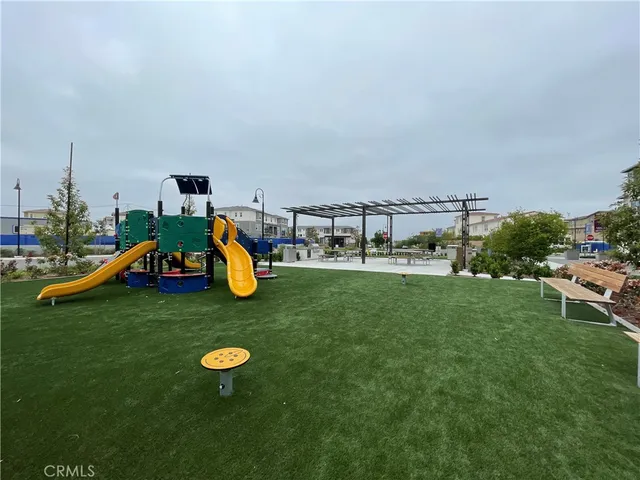 a childrens park with lots of swings and slides