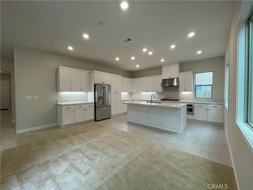 145 Denali Lake Forest, CA 92630 - Photo 2 of 17 a large white kitchen with kitchen island a sink a center island stainless steel appliances and a cabinets