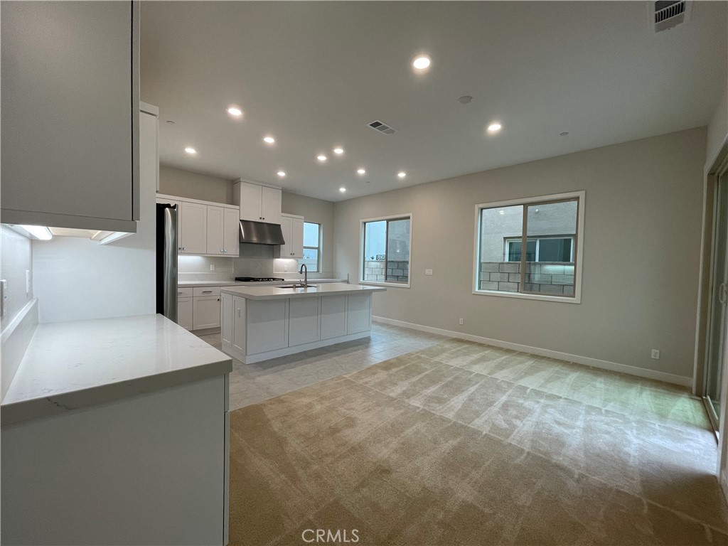 145 Denali Lake Forest, CA 92630 - Photo 3 of 17 a kitchen with stainless steel appliances kitchen island granite countertop a refrigerator sink and stove