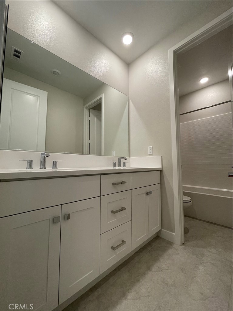 145 Denali Lake Forest, CA 92630 - Photo 10 of 17 a bathroom with double sink and a mirror