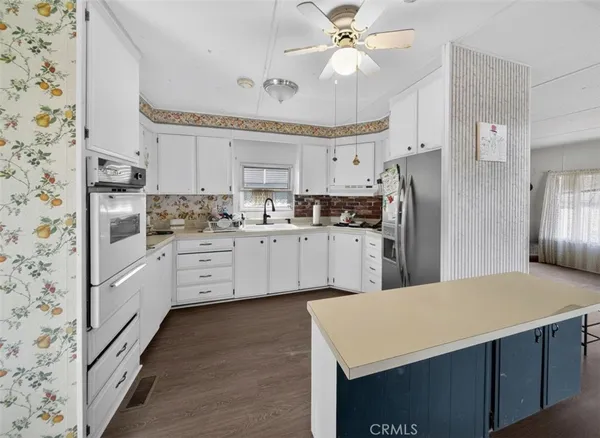 a kitchen with stainless steel appliances a refrigerator sink and cabinets