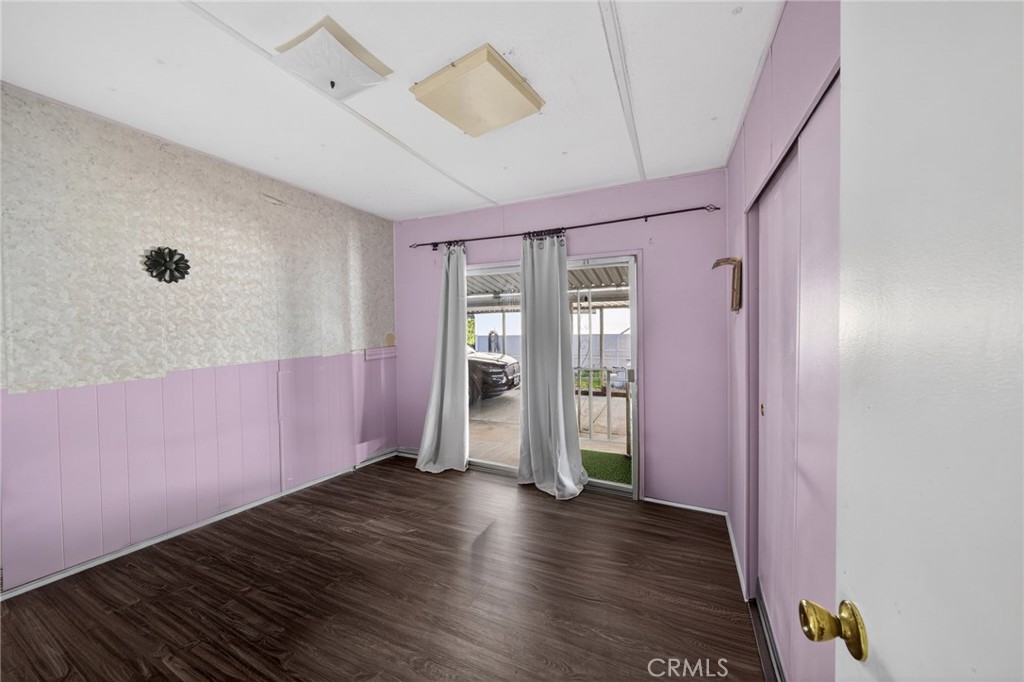 12656 2nd Street, Unit 55 Yucaipa, CA 92399 - Photo 16 of 29 a view of an empty room with wooden floor and a window