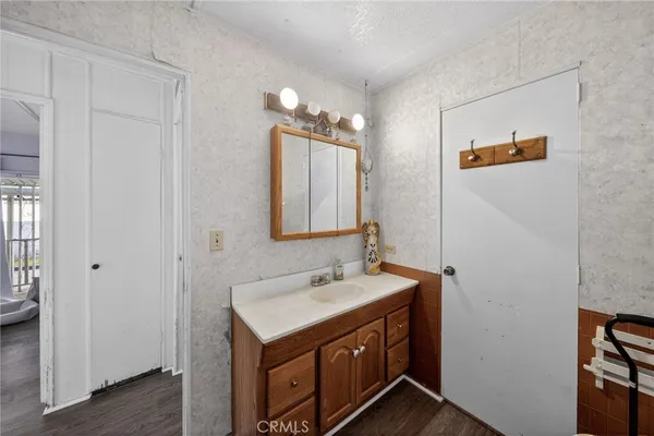 a bathroom with a sink vanity and a mirror