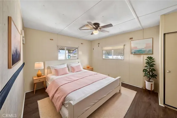 a bedroom with a large bed and a chandelier