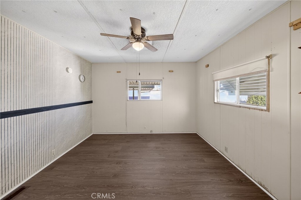 12656 2nd Street, Unit 55 Yucaipa, CA 92399 - Photo 22 of 29 an empty room with wooden floor fan and windows